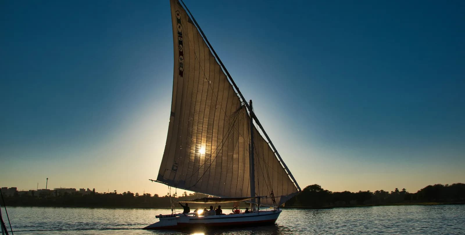 Traditional felucca sailing at sunset on the Nile